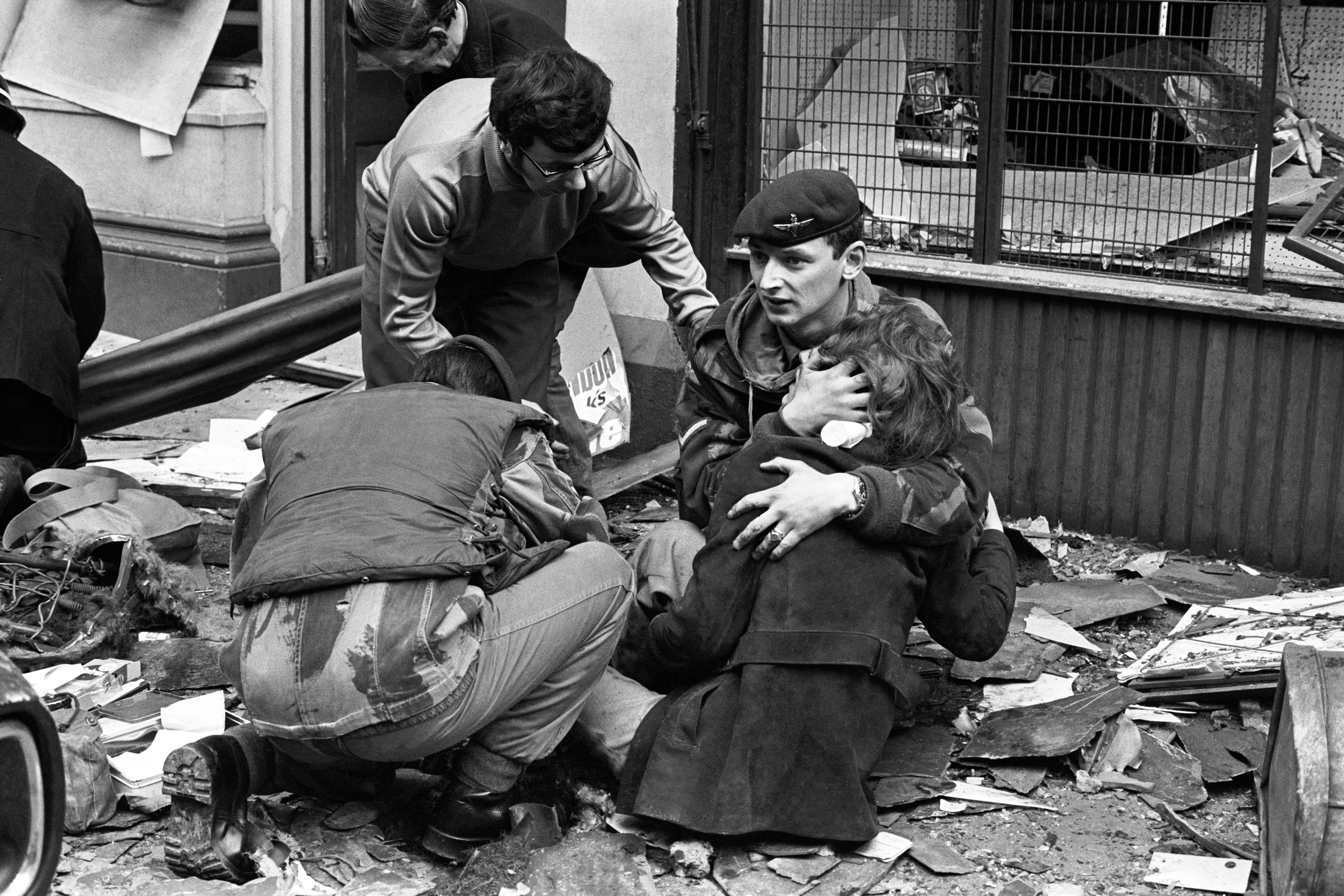 A British paratrooper comforts a young girl who was wounded by an IRA bombing in Belfast, Northern Ireland in 1972. The bomb exploded in a busy street, killing 7 people and wounding 148. The IRA did numerous bombings like these in the early 1970s as it went on the offensive, a time known as "The Troubles". Bombing targets were military or political locations, but also markets and economic centers in Northern Ireland and England, which resulted in many civilians deaths over the years. This lasted on and off until a cease fire was finally agreed upon in 1997.