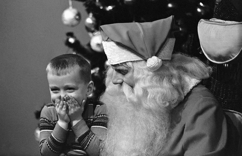 12/16/1960-Chicago, IL- Too embarrassed for words, four-year-old Eddie Waymel tries to cover his giggles while attempting to tell Santa what he wants for Christmas. The youngster just couldn’t seem to get the words out during his meeting with Santa at a Chicago department store. Maybe the latter’s beard tickled Eddie’s fancy.