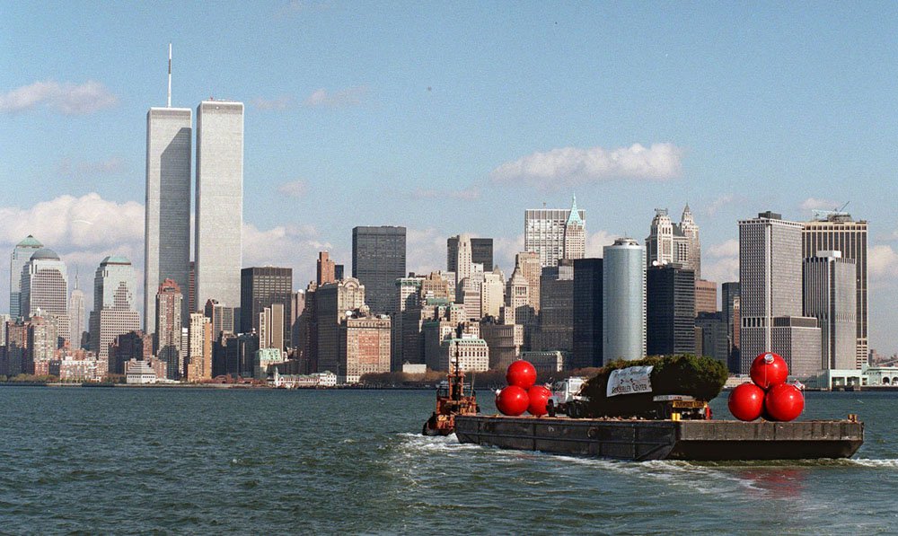 The Rockefeller Center Christmas tree loaded onto a barge makes its way down the Hudson River Wednesday, Nov. 12, 1997, in New York. The trip over the George Washington Bridge was getting tougher and tougher. The Lincoln Tunnel was too much of a squeeze. So the tree will be forsaking its annual highway commute and traveling by boat this year to Rockefeller Center.