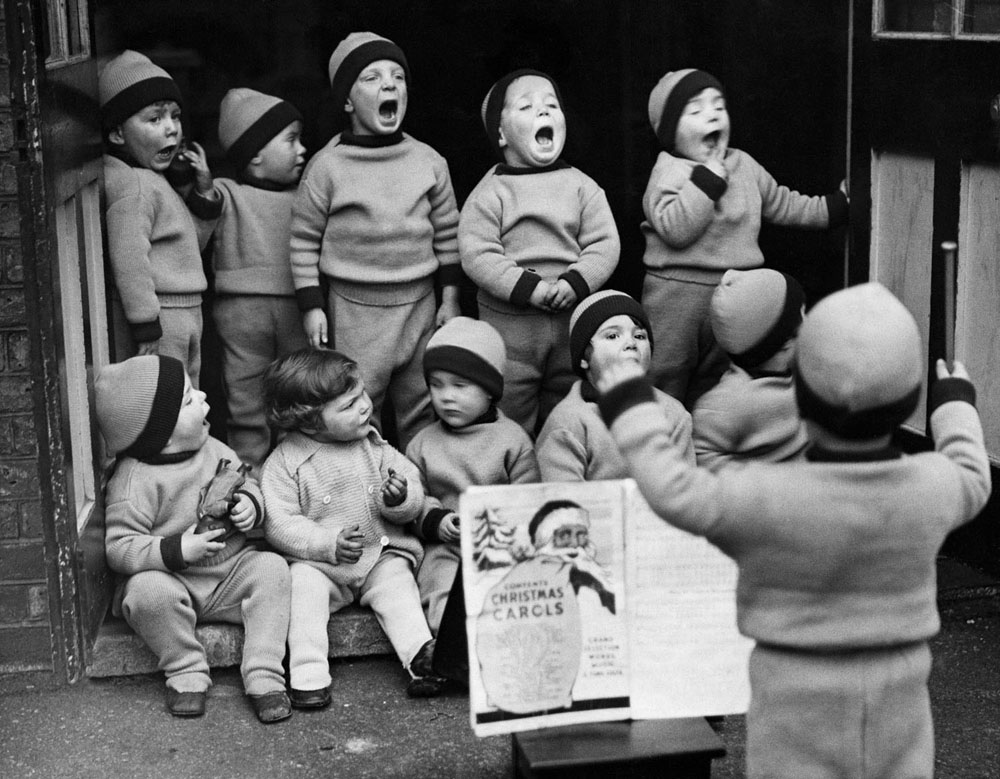 Toddlers awaiting adoption at the Homeless Children’s Aid Society, rehearse their Christmas party songs. December 01, 1934.