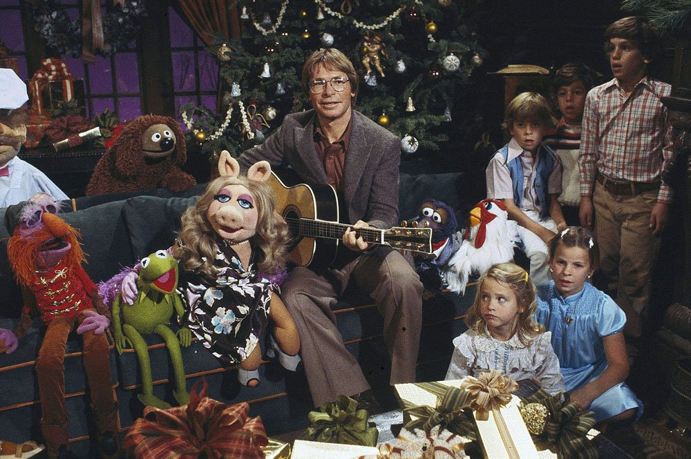 Singer John Denver, with children, aged 6-10, at a taping session Nov. 15, 1979 for his upcoming holiday television special, “John Denver and the Muppets, A Christmas Together.” The show was broadcast on ABC-TV, Dec. 5, 1979, 8-9 pm. Denver told the yuletide story of “Silent Night” to his small guests, and they are joined by Kermit the Frog, Miss Piggy, Fozzie Bear, and all the famed Jim Henson Muppets in sing the the traditional carol.