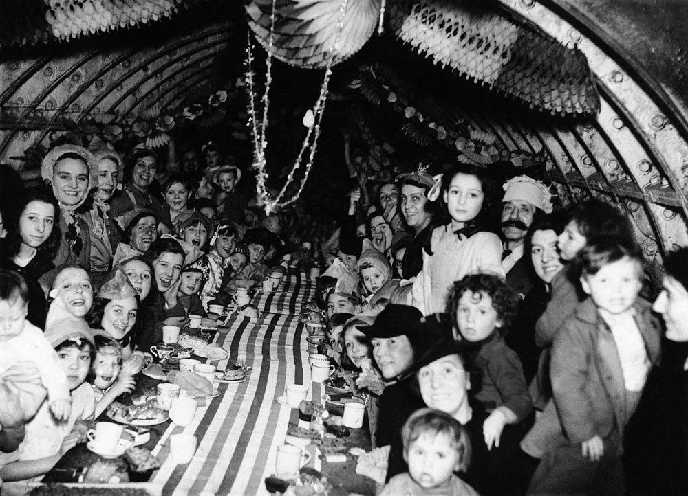 London children enjoying themselves at a Christmas Party, Dec. 25, 1940, in an underground shelter.