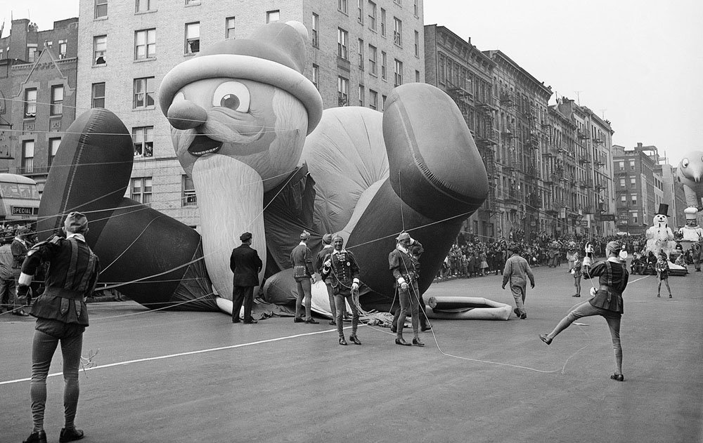 Parade participants hold ropes attached to the Santa Claus parade balloon as it collapses during the annual Macy’s Thanksgiving Day Parade in New York City.