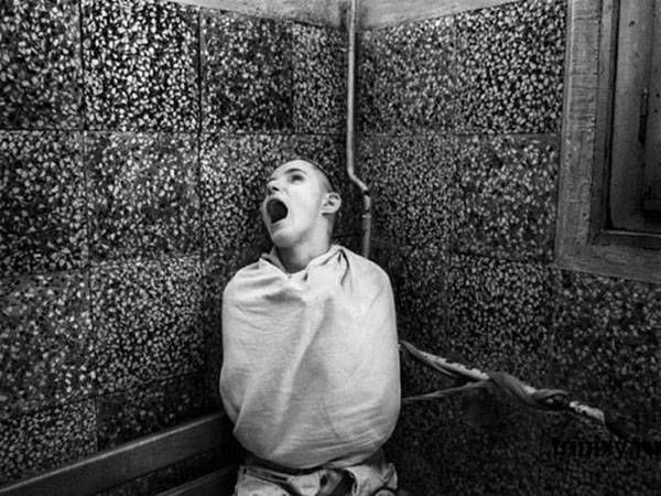 All Tied Up: 
George Georgiou took this horrifying photo at the Serbian Psychiatric Hospital while he was working in the country between 1999 and 2002.
