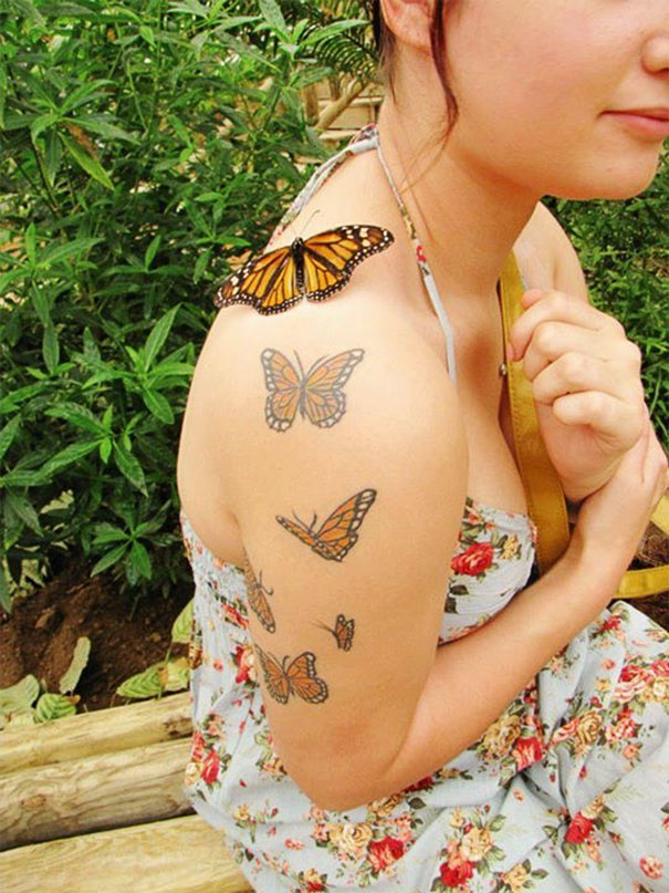 butterflies going up arm tattoo