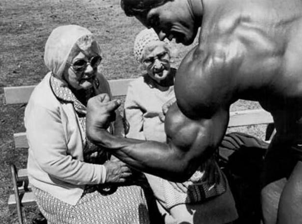 Arnold Schwarzenegger showing off his guns to some elderly women - 1970s
