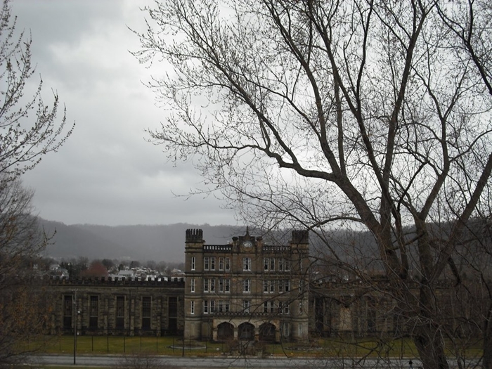 West Virginia State Penitentiary, Moundsville, West Virginia.

An abandoned Gothic style prison that was built in 1876 and closed it's doors in 1995. Over 100 people were executed there, via electric chair. Now if that's not an invitation for vengeful spirits to hate fuck the tourists that visit the place for their night time tours, I don't know what is.