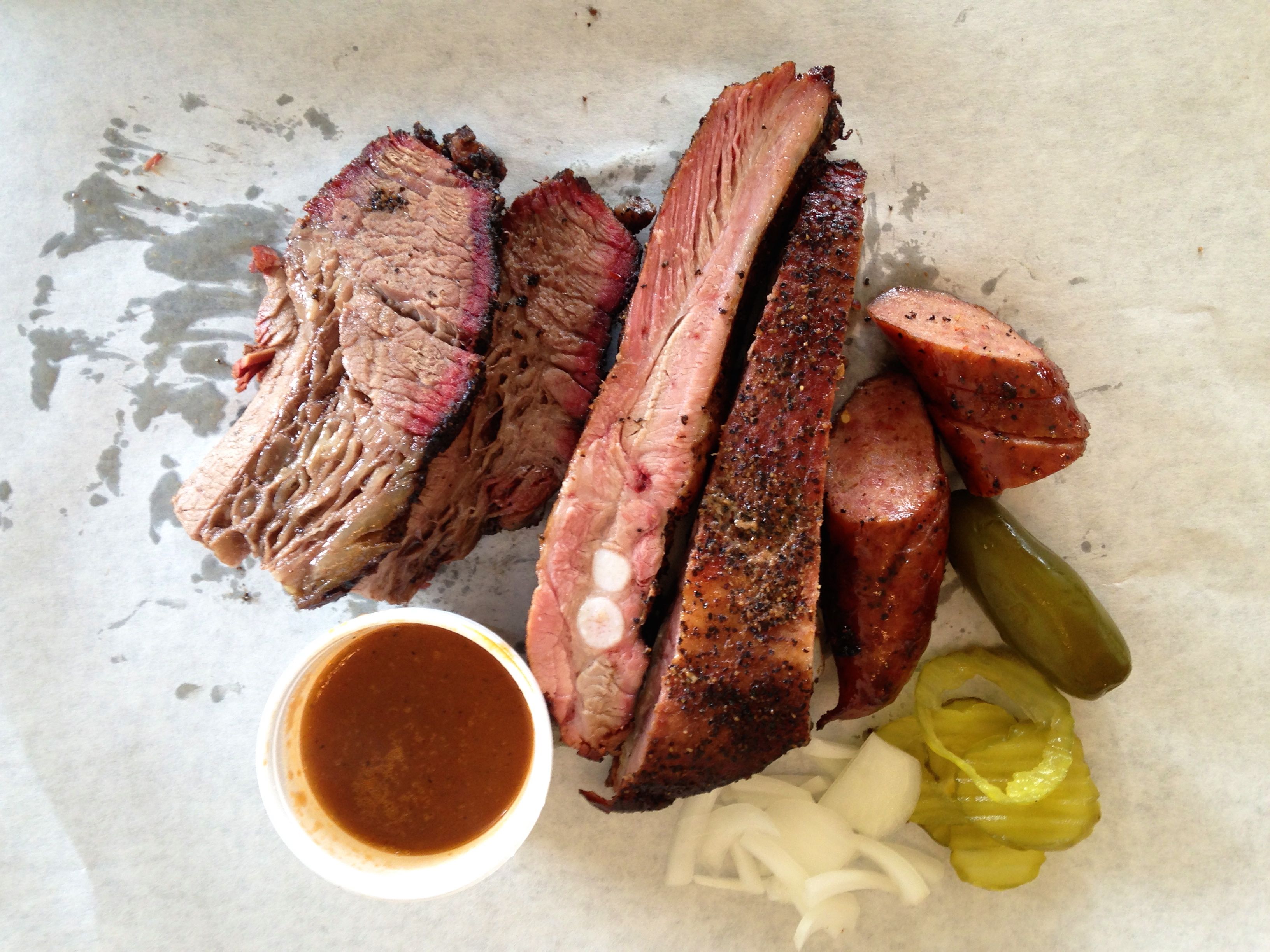 Central Texas, Is known for serving up huge amounts of brisket and ribs with a smoke over oak or pecan wood. The sauce isn't as important in Central Texas and is usually used as a side dipping sauce, putting all focus on the protein that is produced from the pits. Whereas East Texas, traditionally uses both part beef and pork that is chopped finely and placed on sandwiches typically, and drenched and a  sweet tomato and brown sugar based sauce, and this style BBQ can be found throughout the Gulf Coast ranging from Louisiana all the way to Georgia.