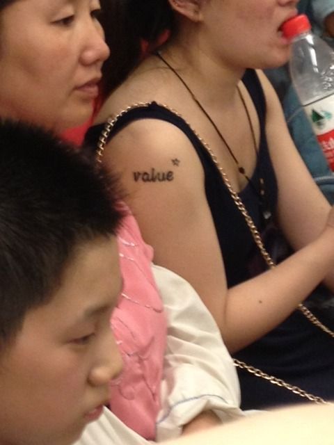 chinese person with english tattoo - value