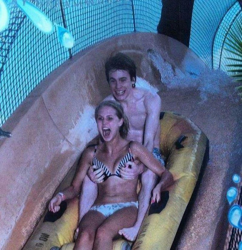 guy grabbing a girls boobs on a roller coaster