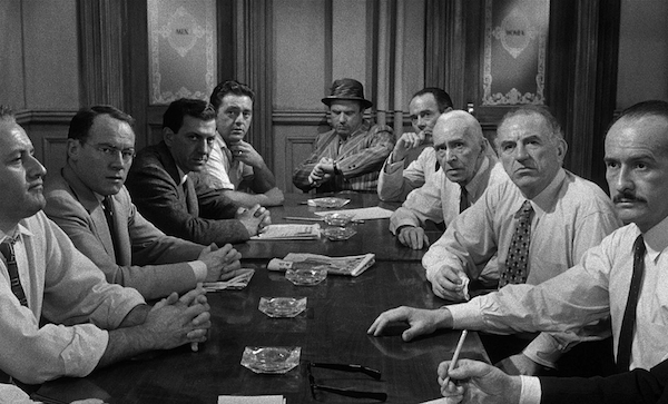 12 Angry Men (1957)
For Sydney Lumet’s first film, this one’s a masterpiece. The entire film involves a jury deliberating over the guilt or innocence of a man on trial, and keeping all the action within the jury room, makes this film. The camera work is stellar, keeping everything tight and close, creating a sense of tension and claustrophobia.
While the story itself does have it’s predictable twists and turns, it’s the atmosphere and thrilling nature of the narrative that makes this film one of the best.