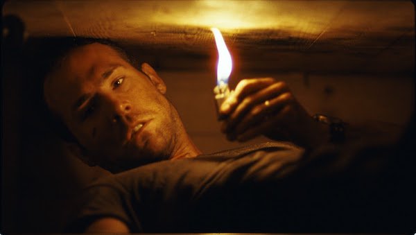 Buried (2010)
If you were to make a list of comedic actors that could carry a serious drama all by themselves, Ryan Reynolds wouldn’t make that list. After 2010’s Buried, however, he’ll never be misjudged again.
Reynolds plays a truck driver in Iraq, who finds himself buried alive in a coffin, with no idea why. There are no cutaways, no action outside of what happens inside the box, and as you watch, you’re grow more and more claustrophobic and anxious for his fate. It’s surprising how well this film keeps your attention for over 90 minutes and the ending is everyone’s worst nightmare.