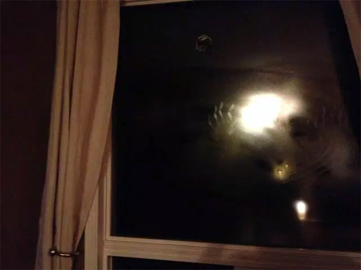 When this homeowner left his living room for just one minute, he returned to find this ghostly image peering through the window at him. Totally freaked out and scared, the quick-thinking man managed to snap this quick picture, proving that there is such a thing as spirits and ghosts.