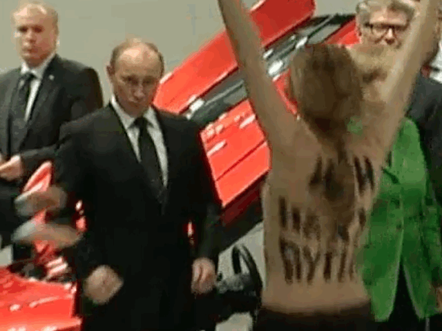 GIF of topless protestor at Putin who gives thumbs up