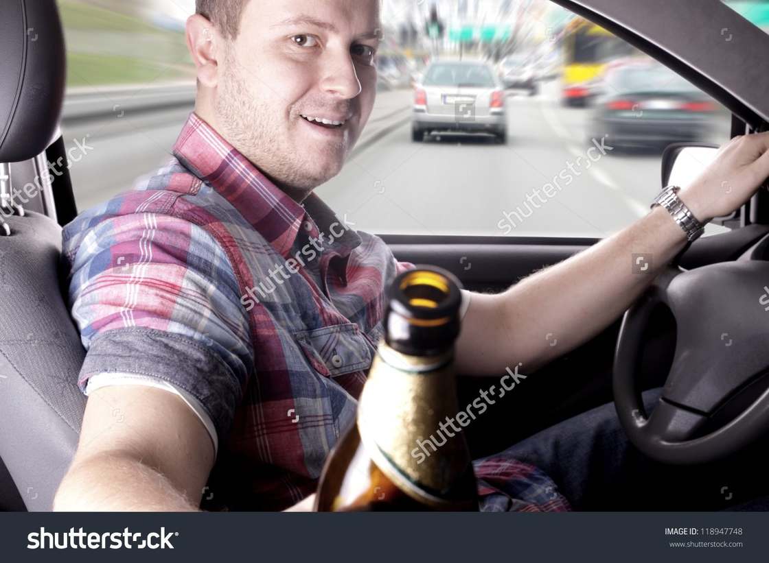 Person driving wrongly offering passenger a drink
