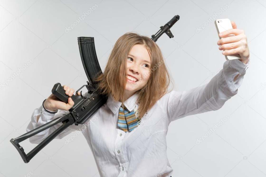 Basic girl in school uniform holding an assault riffle and taking a selfie.
