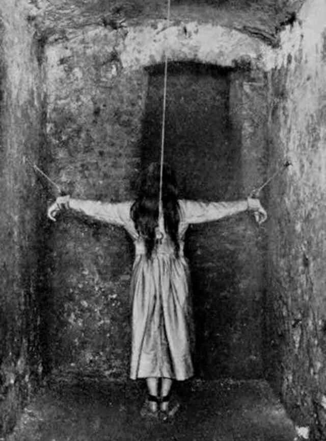 A woman is restrained in an Asylum in France in 1900.