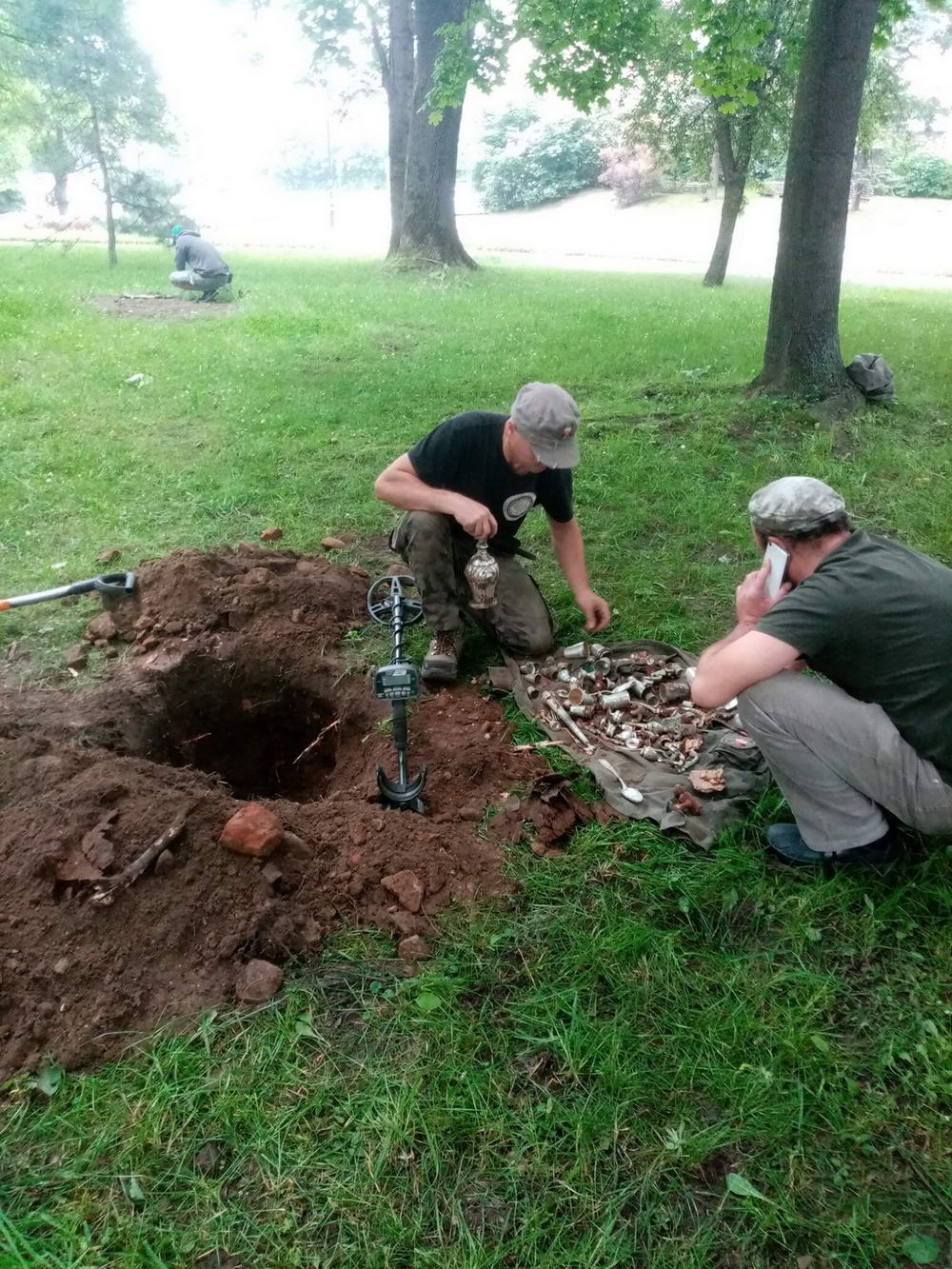 group of men digging up an old silver treasure