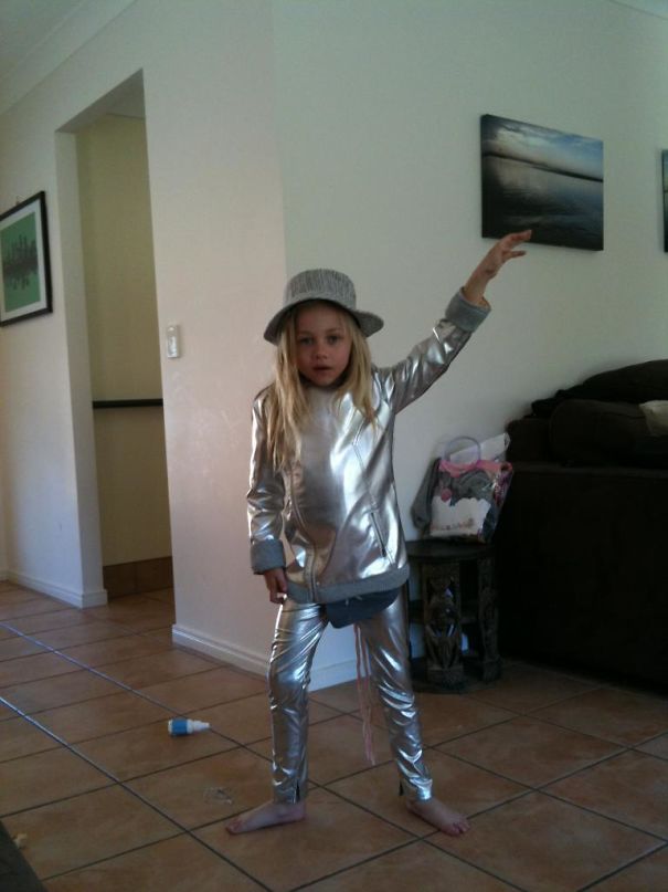 Girl dressed in all silver looking outfit