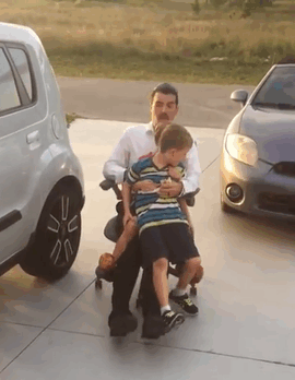 dad with kids on roller chair and falls over