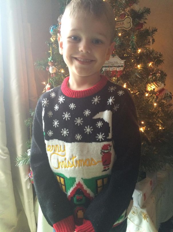 kid on christmas morning wearing ugly sweater