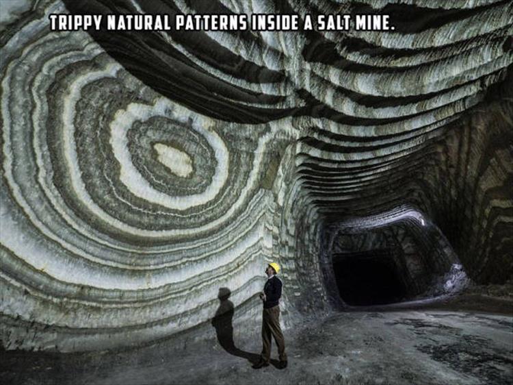 random picture of trippy natural patterns inside a salt mine with person wearing hard hat for scale
