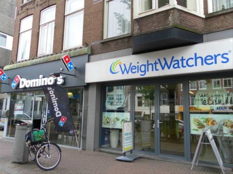 random picture of a weight watchers next to a domino's pizza
