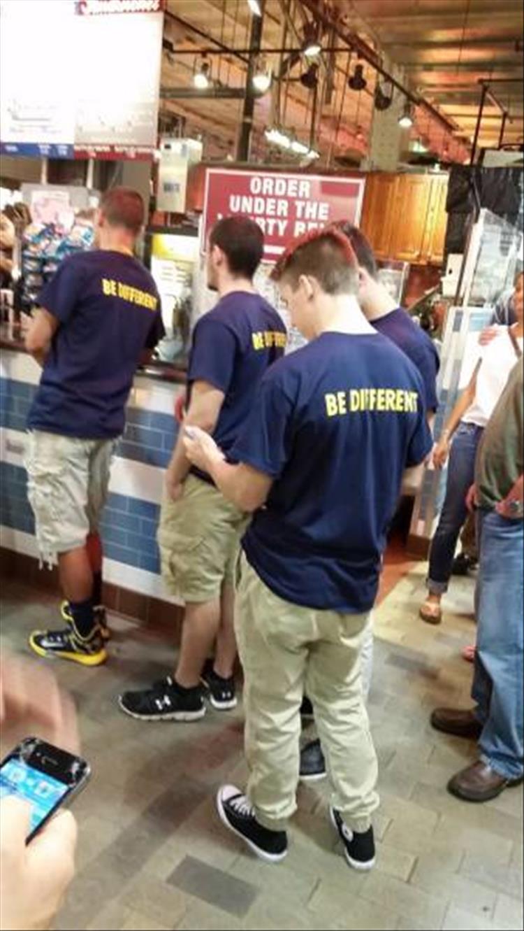 random picture of multiple dudes wearing Khaki pants and a shirt that says be different on the back