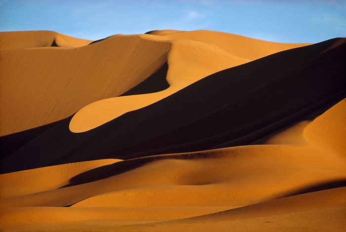 The wind sculpts the dunes of the Sahara Desert in the Erg Bourarhet, Algeria, 1973Image source: Thomas J. Abercrombie