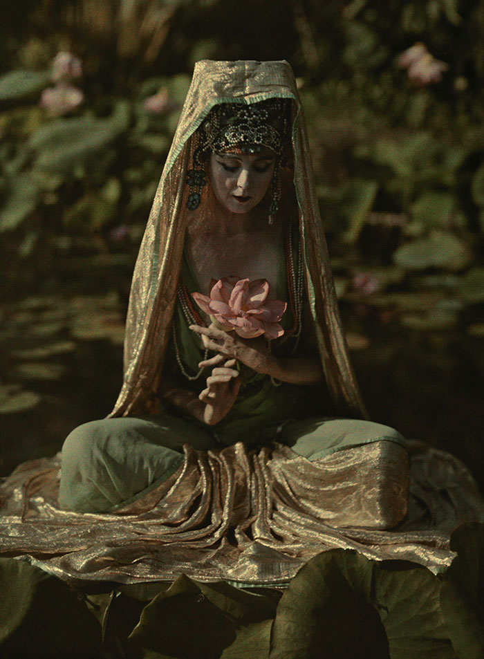 Woman adorned like a Chinese goddess poses in a garden in California, 1915Image source: Franklin Price Knott