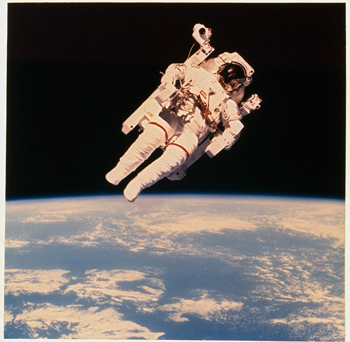 Astronaut Bruce McCandless II floats a few meters away from Space Shuttle Challenger during the historic first use of a nitrogen-propelled manned maneuvering unit in 1984Image source: NASA