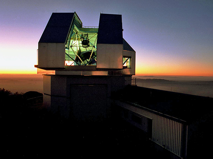 As the sun sinks below the horizon, the WIYN 3.5-meter Telescope atop Arizona’s Kitt Peak prepares to scan the northern night sky. In operation since 1994, the telescope uses a combination of three mirrors, the largest of which weighs over 2 tons and stretches 3.5 meters wide; and advanced imaging instruments; to produce some of the clearest images ever seen of celestial objects and events.