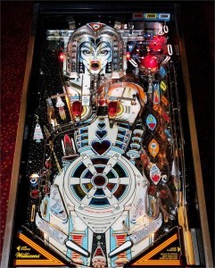 The Machine: Bride of Pin-Bot (1991)
The Machine is the second pinball game in the Pin Bot series. It was also the last game produced by Williams without a dot matrix display. The plot of the game revolves around the female robot, The Machine. Players must activate The Machine’s voice circuits and eyes, as well as help her metamorphose into a human female.