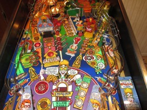Dr. Dude and His Excellent Ray (1990)
Dr. Dude and His Excellent Ray is one of my favorites. The object of the game is to become a Super Cool Dude. Player increases the Dude-O-Meter by collecting the ingredients of ultimate hipness. This pinball machine was one of the last to use an alpha-numeric display. 1980s style music and a colorful cartoon theme complete this excellent dude theme.