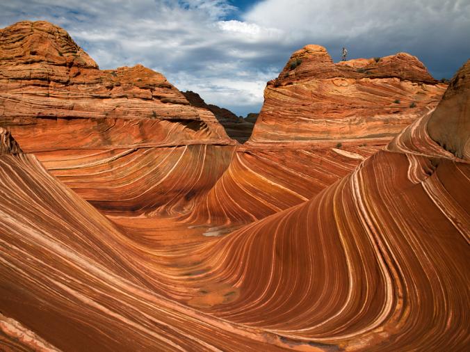 VERMILION CLIFFS NATIONAL MONUMENT, ARIZONA
The Wave is the most famous landform in Arizona's Vermilion Cliffs National Monument, a little-known 300,000 acres of rugged terrain. Flash floods carved this passage through petrified sand dunes, exposing the iron-rich bands.
PHOTOGRAPH BY XU XIAOLIN, LAIF/REDUX