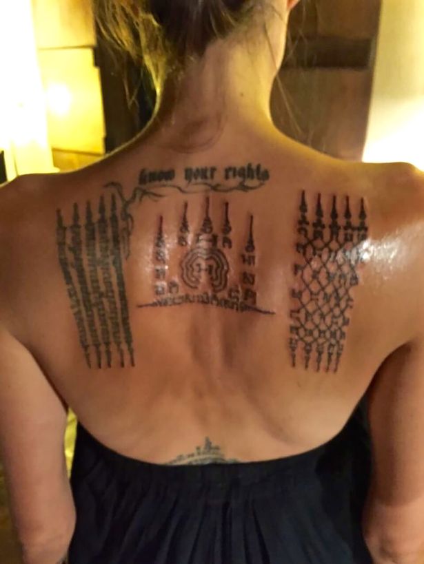 Thai monk gives Angelina Jolie painful tattoos 'binding her' to Brad Pitt - just before their marriage fell apart