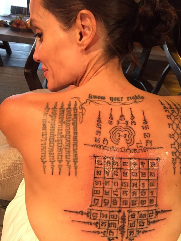 Thai monk gives Angelina Jolie painful tattoos 'binding her' to Brad Pitt - just before their marriage fell apart