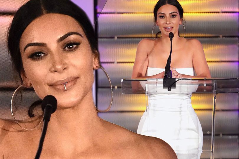 Kim Kardashian looks super slim as she presents a trophy to her executive producer