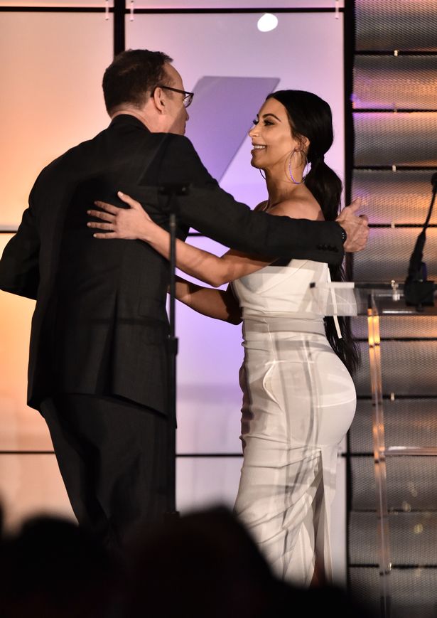 Kim Kardashian looks super slim as she presents a trophy to her executive producer