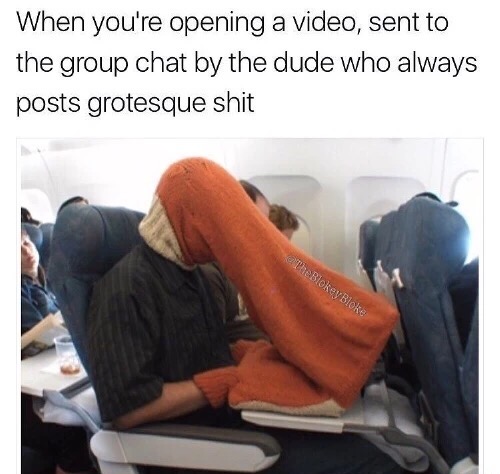 Man wearing funny head gear to watch a movie on the airplane.