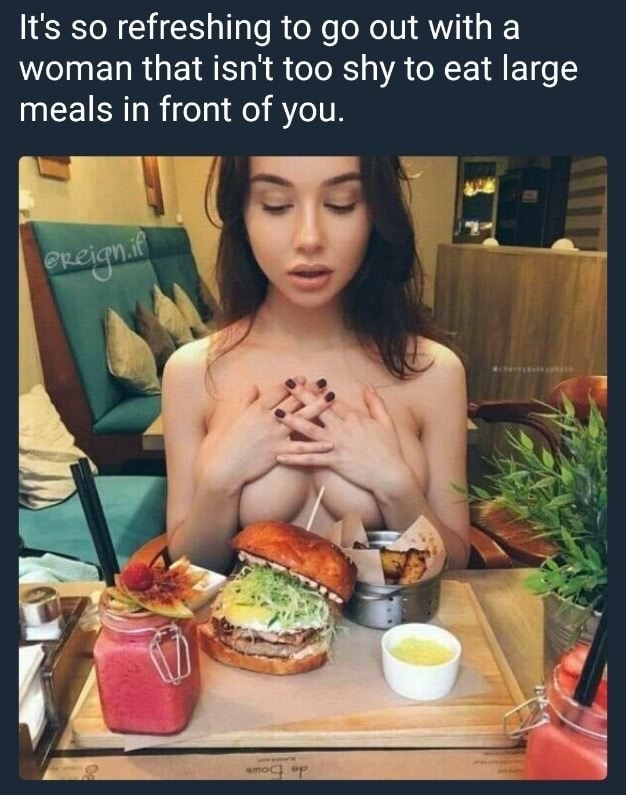 Girl with no top about to eat a huge meal.