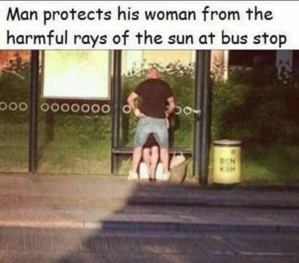 man protecting his woman - Man protects his woman from the harmful rays of the sun at bus stop 000 0000000