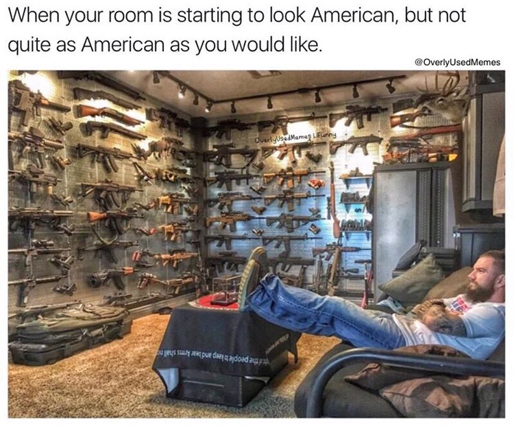Man in room full of guns on the wall