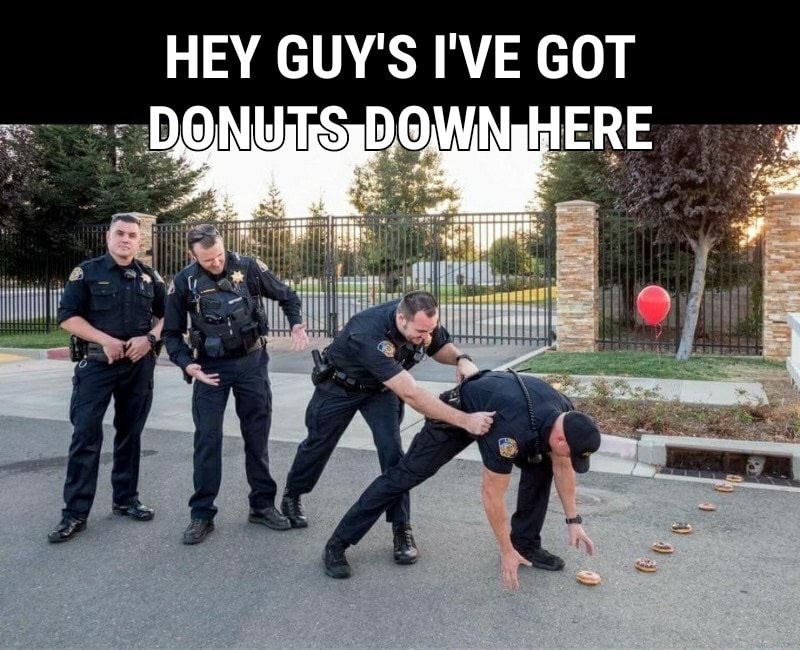 Cops posing for a pic and they can't help not going for those donuts