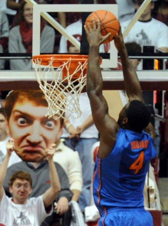 Man at basketball game with giant sign of his angry face
