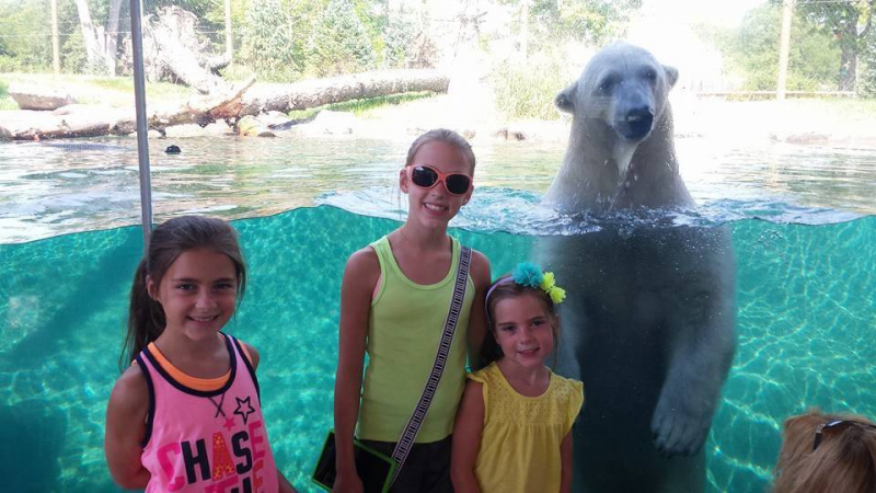 Kids and a bear posing for a pic