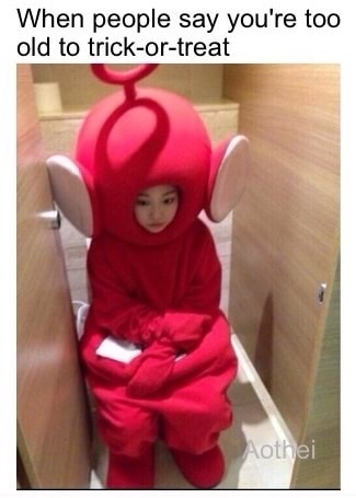Woman dressed as Teletubby alone in the bathroom and sad.