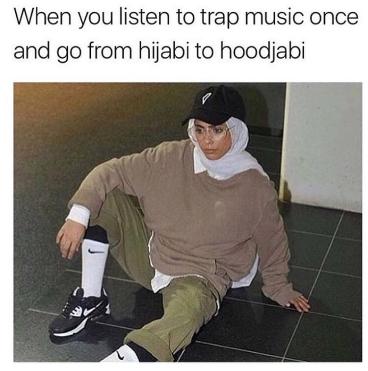 Woman with Hijab sitting on the floor after listening to trap music once and going from hijab to hoodjabi