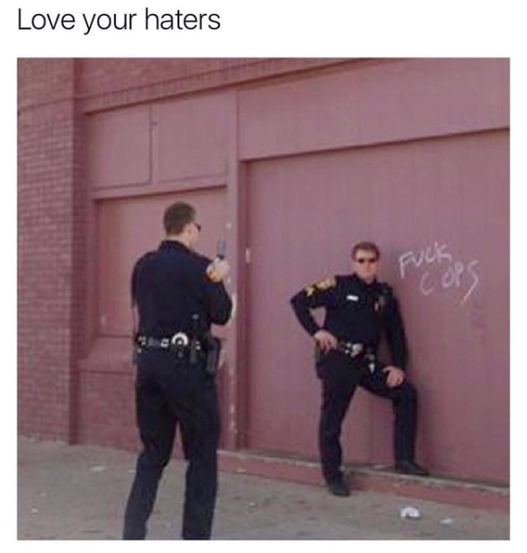 Cops posting jokingly with graffiti against them