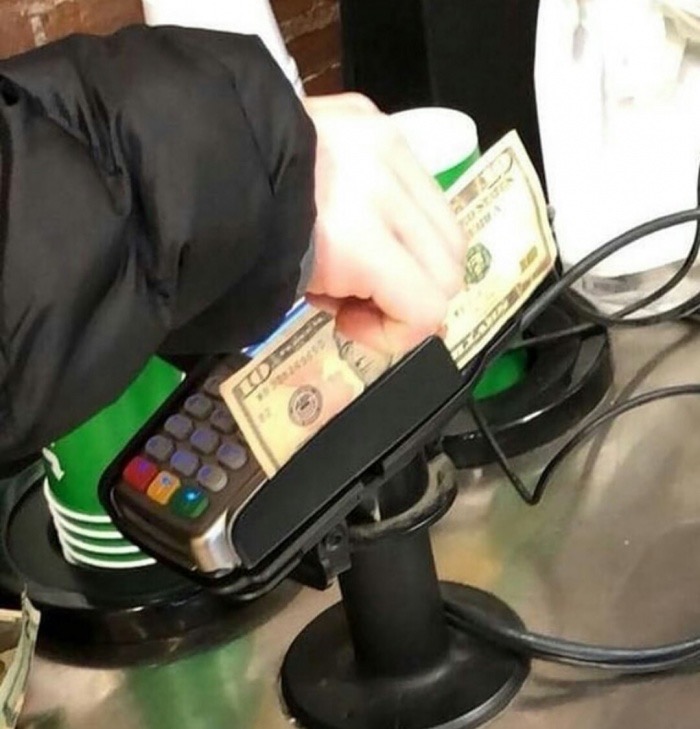 sliding a 10 dollar bill through the credit card reader